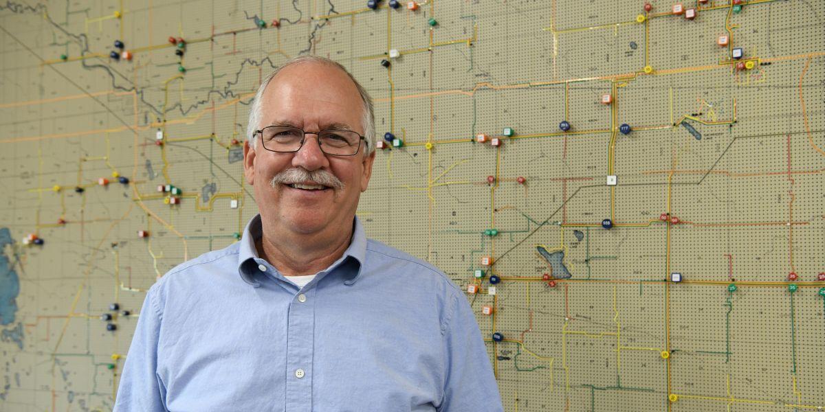 Ron Raypole in front of map