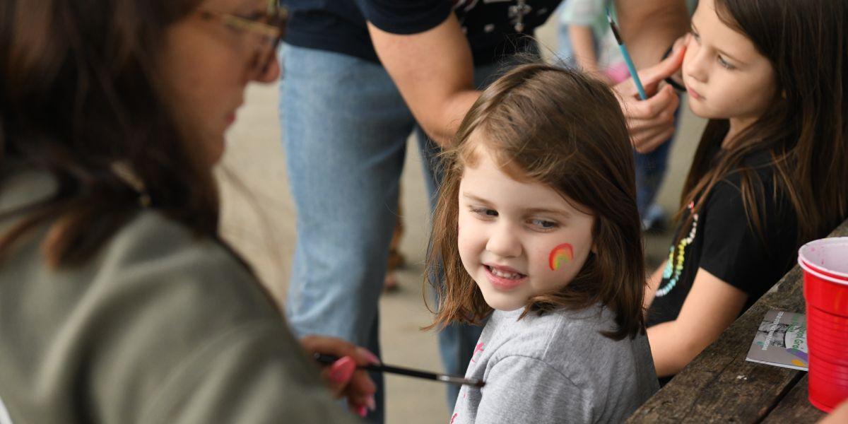 Little girl getting face painted