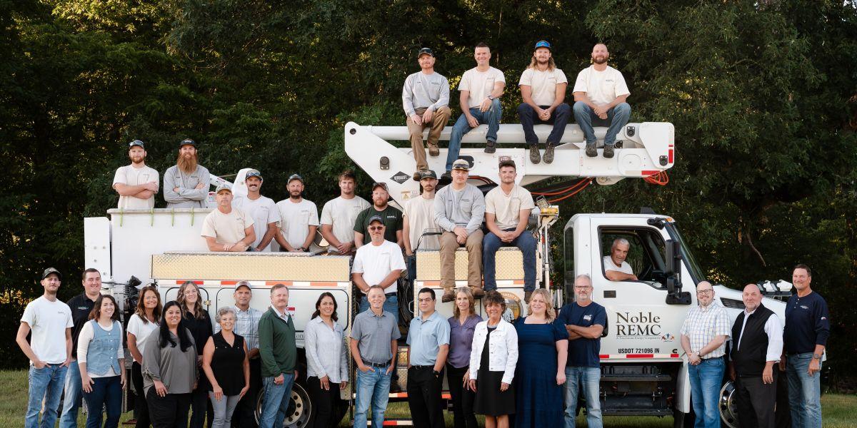 Photo of all Noble REMC employees in front of bucket truck